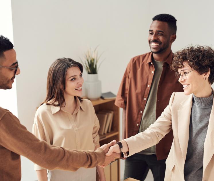 Diverse group of people shaking hands