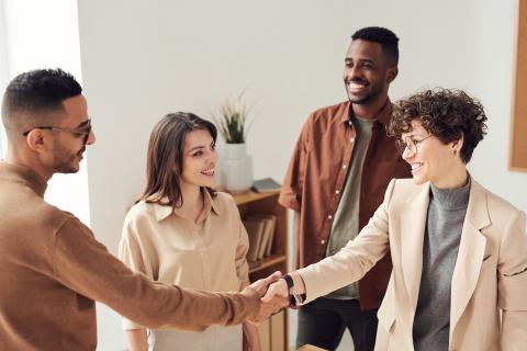 Diverse group of people shaking hands